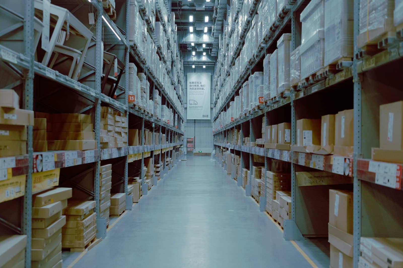 Warehouse aisle between tall storage racks